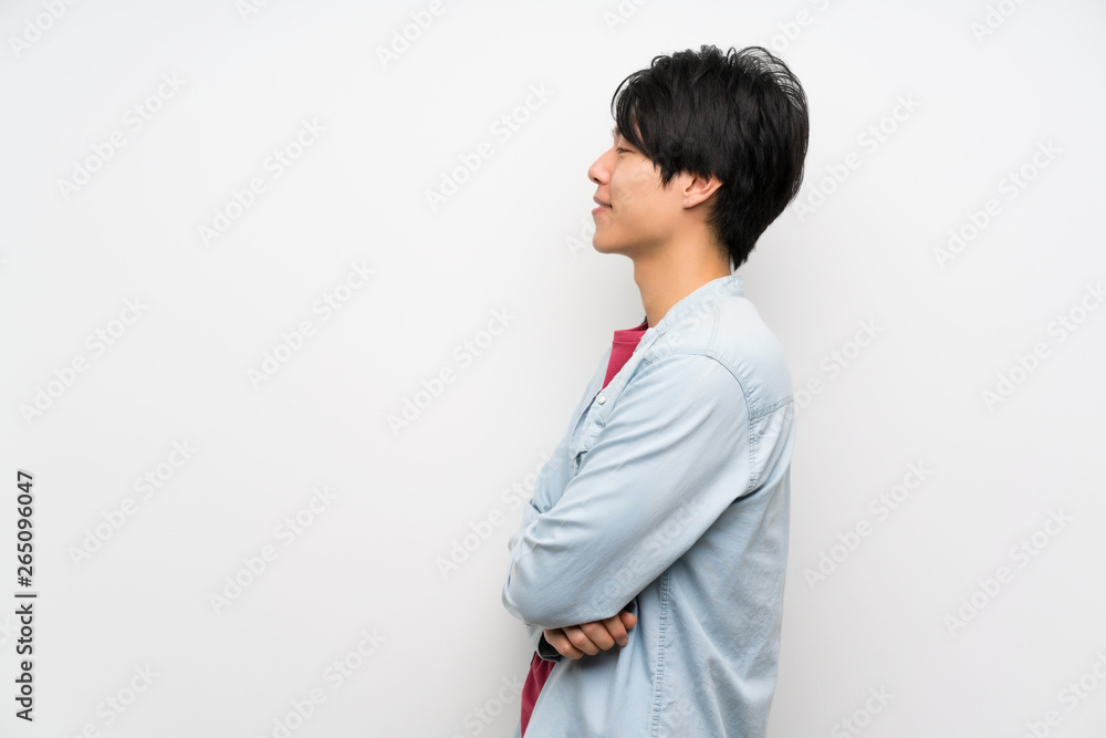 Asian man on isolated white background in lateral position Asian man on isolated white background in lateral position