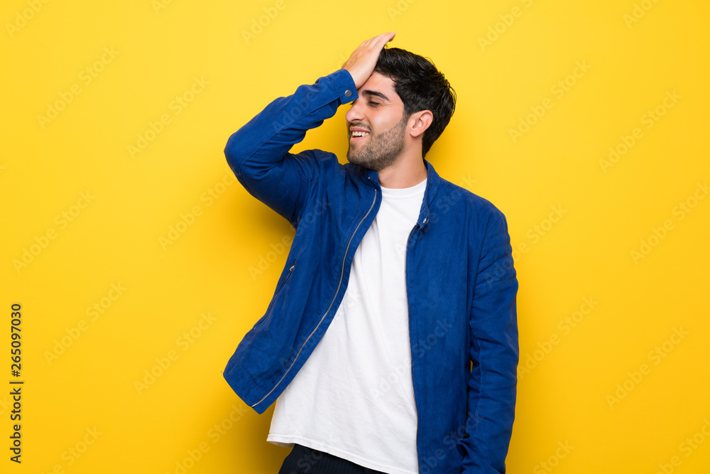 Man with blue jacket over yellow wall has realized something and intending the solution Man with blue jacket over yellow wall has realized something and intending the solution
