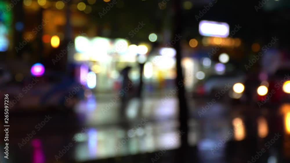 Wet asphalt. Defocused image of street lights and neon advertising. Tropical downpour. Abstract moving background. Bokeh of car lights. Wet asphalt. Defocused image of street lights and neon advertising. Tropical downpour. Abstract moving background. Bokeh of car lights.