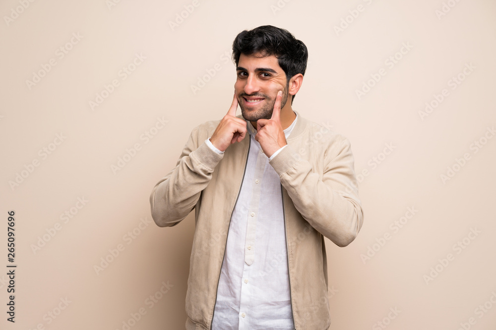 Young man over isolated wall smiling with a happy and pleasant expression Young man over isolated wall smiling with a happy and pleasant expression