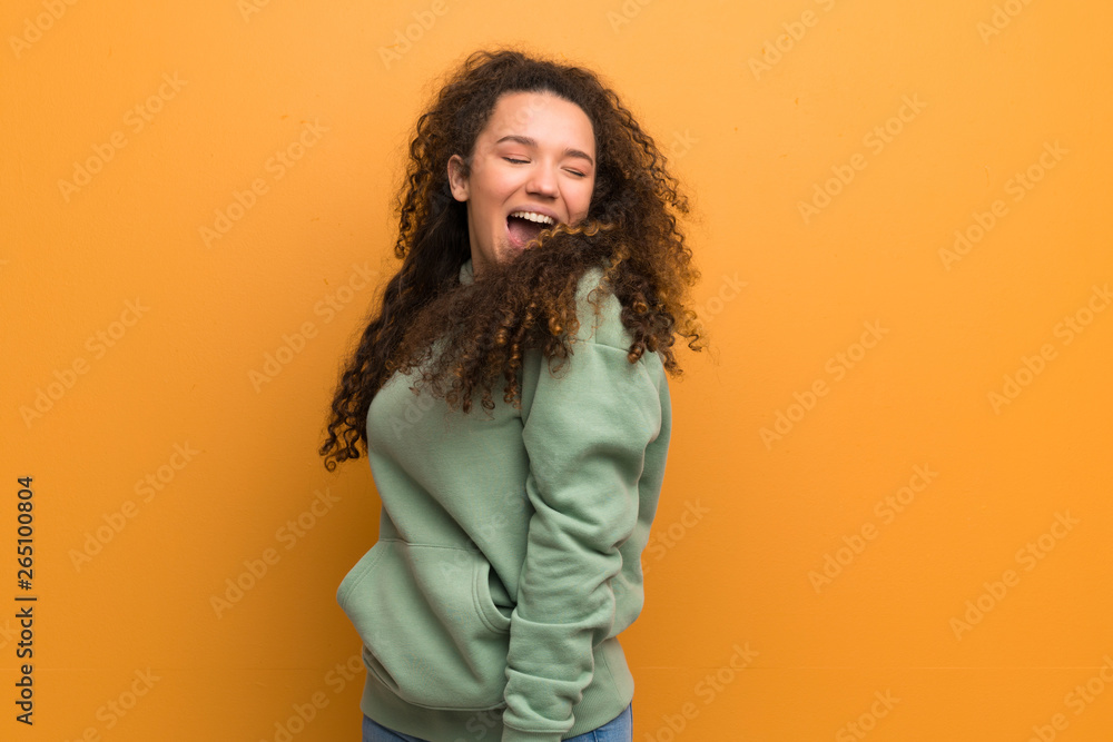 Happy Teenager girl over ocher wall. Happy Teenager girl over ocher wall.