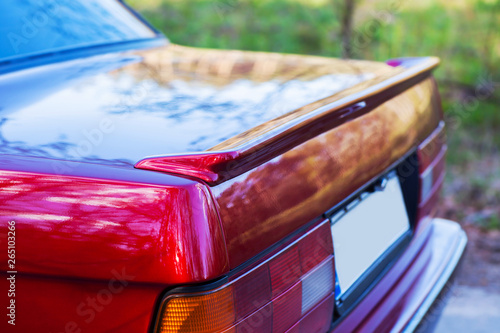 The back of a red retro car with a small wing