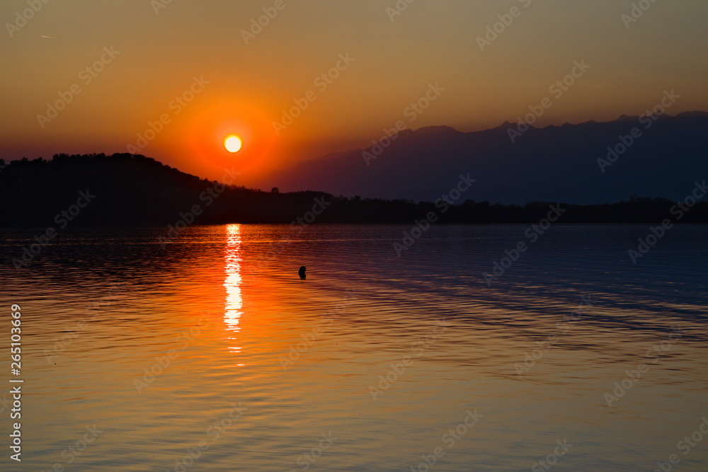 Warm sunset on the Viverone Lake, Piedmont, Italy Warm sunset on the Viverone Lake, Piedmont, Italy
