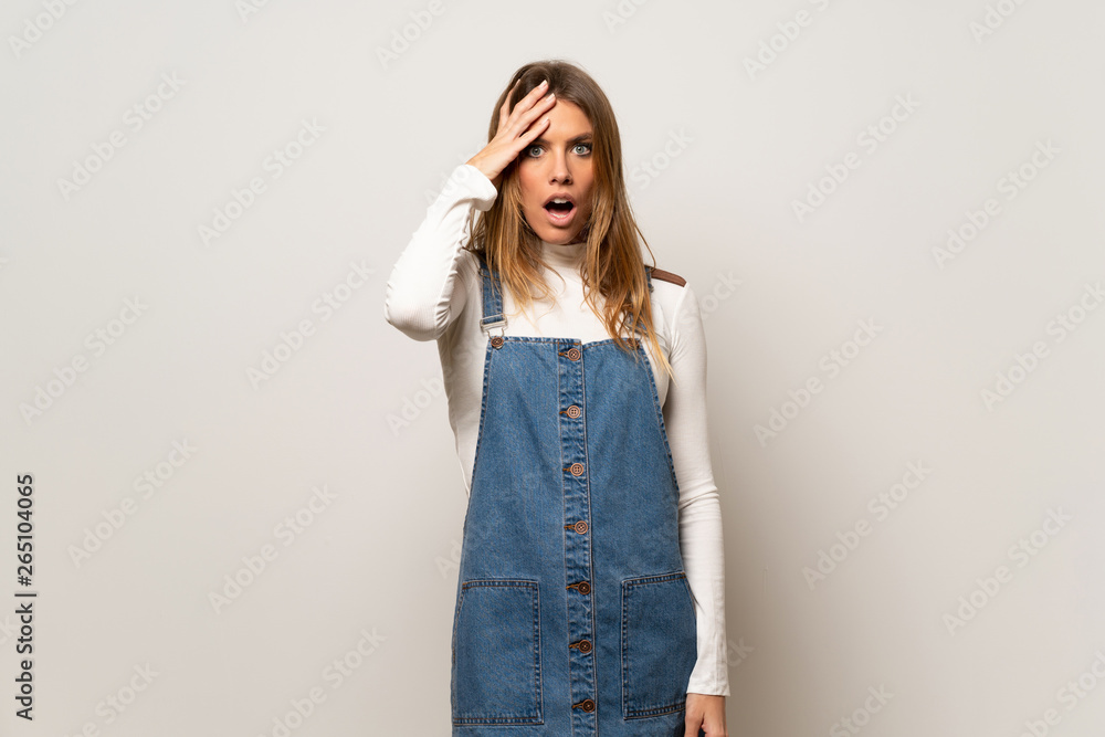 Beautiful woman over isolated white wall with surprise and shocked facial expression Beautiful woman over isolated white wall with surprise and shocked facial expression
