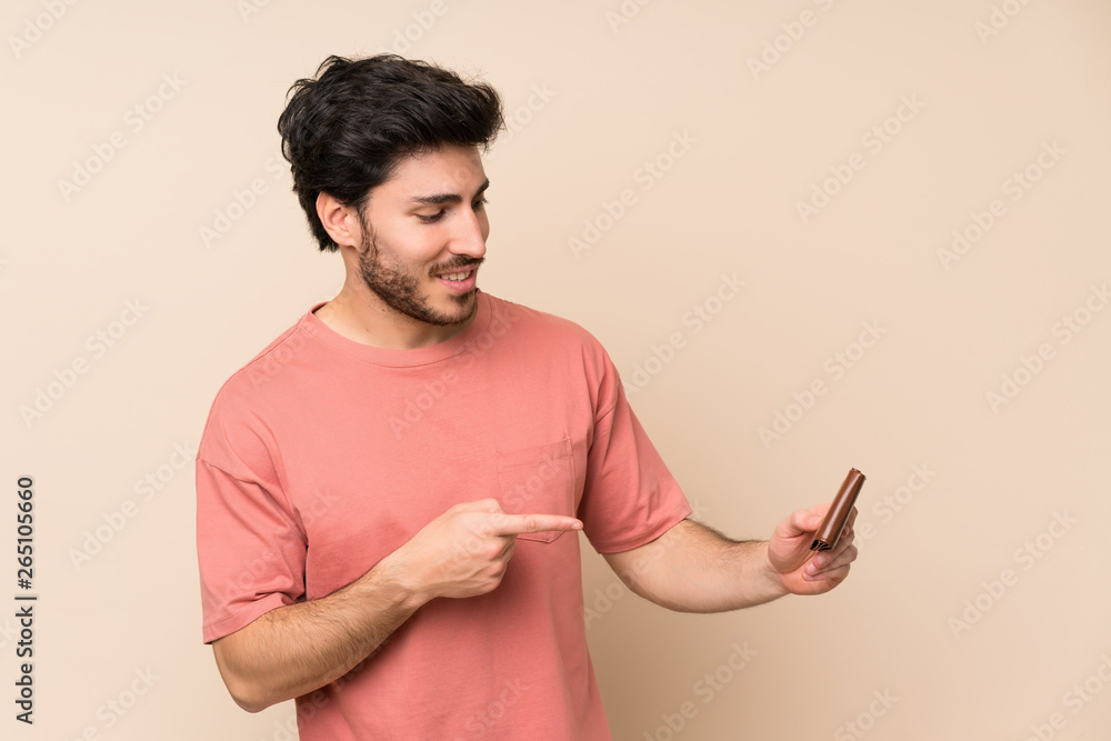Handsome man holding a wallet Handsome man holding a wallet