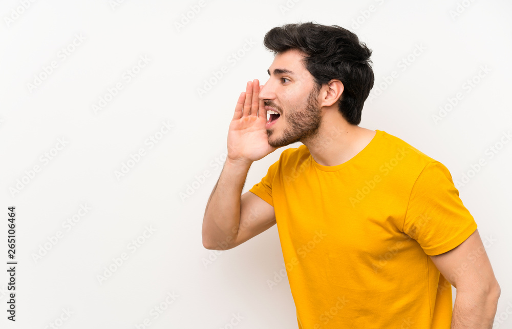 Handsome over isolated white wall shouting with mouth wide open Handsome over isolated white wall shouting with mouth wide open