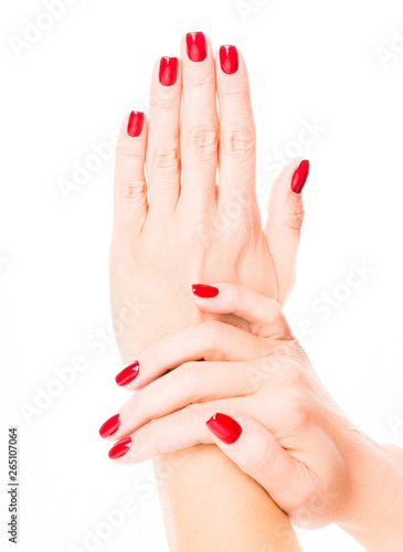 Hands of a young woman with red manicure on nails