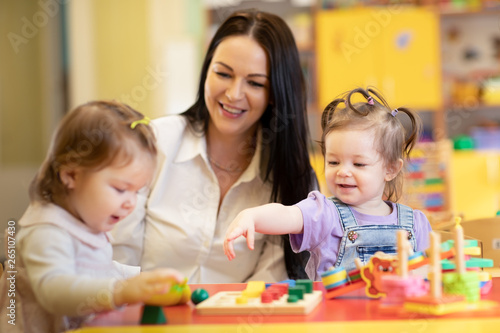 Nursery teacher looking aft...