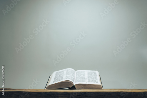 Fototapeta Open Holy Bible on a old oak wooden table