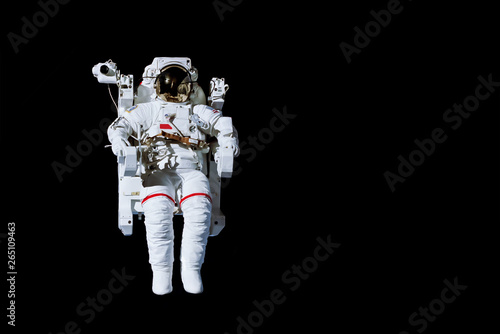 Astronaut with a jetpack isolated on black background with copy space -  Elements of this image are furnished by NASA photo