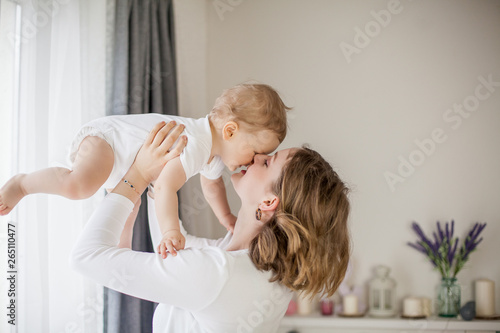 Beautiful mother and little son 9 months in the home interior. Cozy. Baby. Motherhood. photo