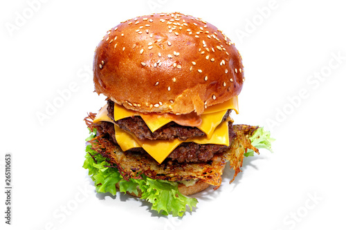 Juicy beef burger with potatoes, cheese and salad. Close-up. photo