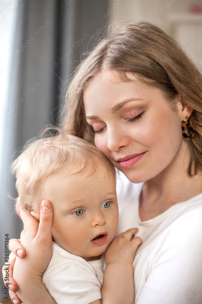 Beautiful mother and little son 9 months in the home interior. Cozy. Baby. Motherhood. Beautiful mother and little son 9 months in the home interior. Cozy. Baby. Motherhood.