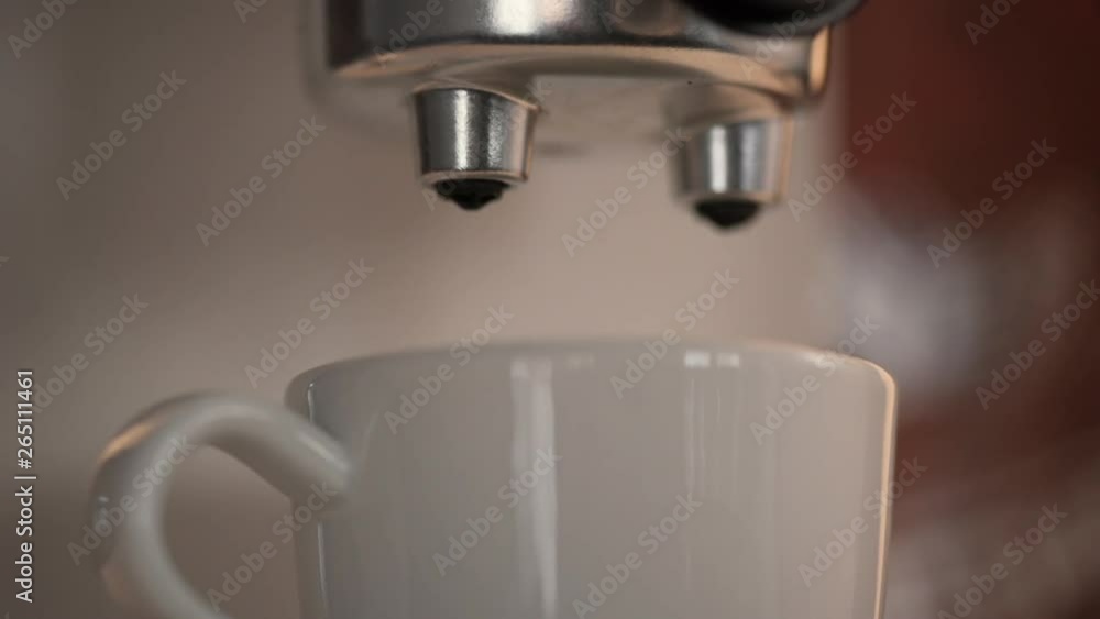 Close-up of making espresso coffee that is poured into a cup shot in SLOW MOTION 120 Close-up of making espresso coffee that is poured into a cup shot in SLOW MOTION 120