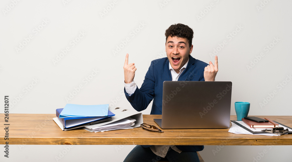 Business man in a office pointing up a great idea Business man in a office pointing up a great idea