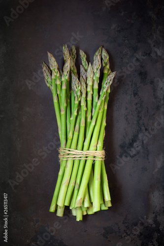 Fresh green asparagus against dark rustick background. Overhead view