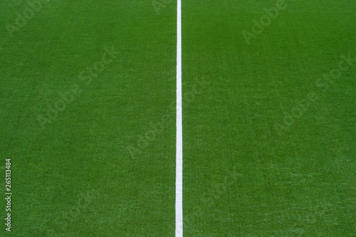Artificial green turf texture background with white line marks