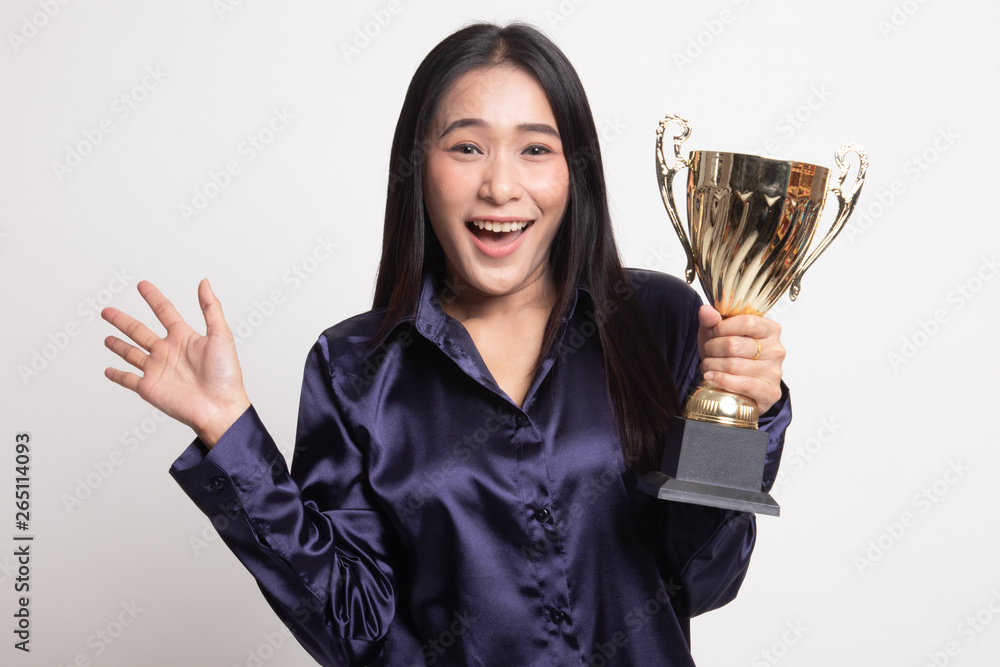 Successful young asian woman holding a trophy. Successful young asian woman holding a trophy.