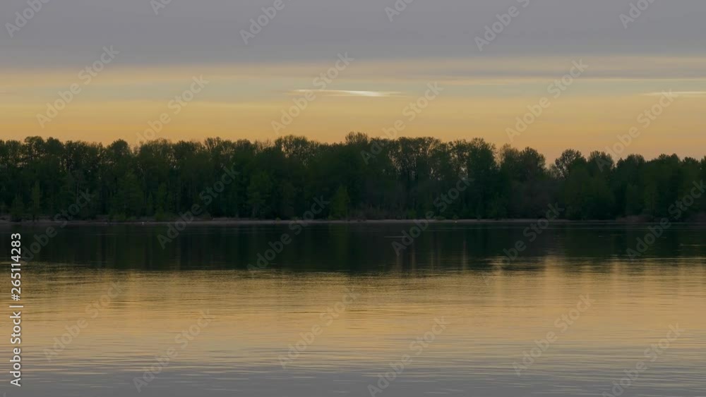 Calm River at sunrise with reflection pan across Calm River at sunrise with reflection pan across