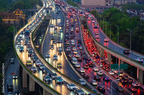 Traffic jam in the rush hour on highway. Cars on bridges and roads in Shanghai Downtown, China at night.