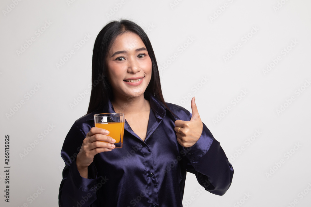 Young Asian woman thumbs up drink orange juice. Young Asian woman thumbs up drink orange juice.