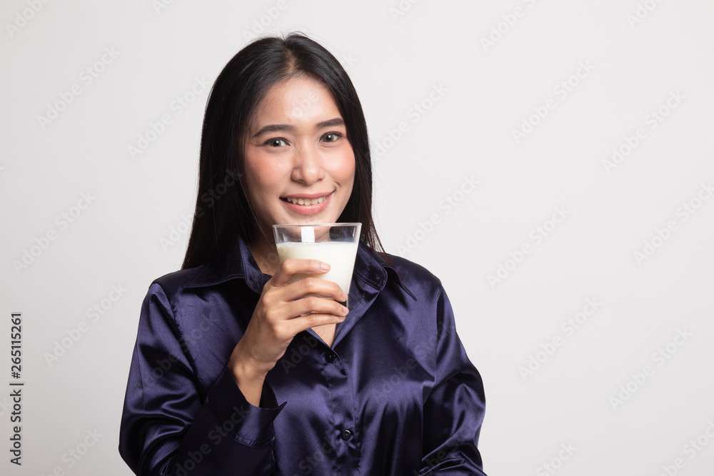 Healthy Asian woman drinking a glass of milk. Healthy Asian woman drinking a glass of milk.