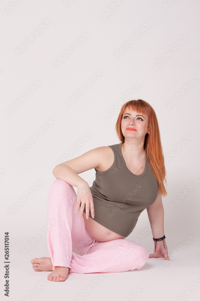Happy pregnant woman is looking at something. Perinatal medicine. Maternal and fetal health. Empty place for inscription. Happy pregnant woman is looking at something. Perinatal medicine. Maternal and fetal health. Empty place for inscription.