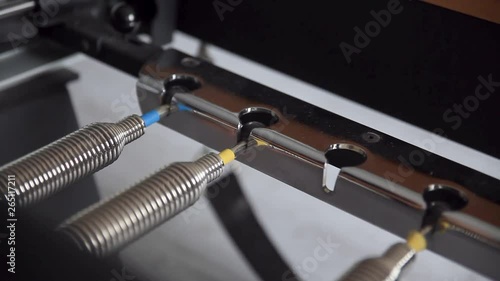 Close-up of a woman's hand arranging reformer pilates machines weight strings