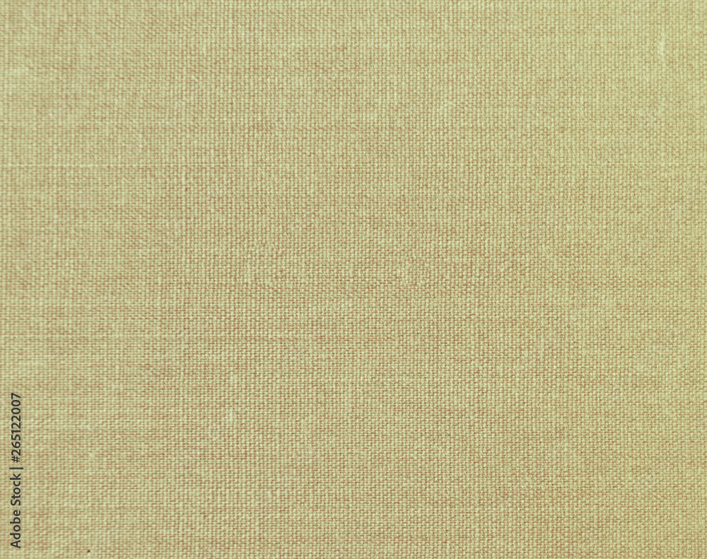 Textured background of beige natural textile Textured background of beige natural textile
