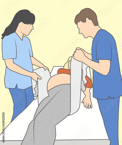 Pregnant woman with nurse supporting baby & mother with towel