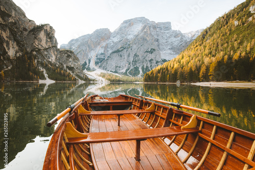 Traditional rowing boat on a lake in the Alps in fall photo