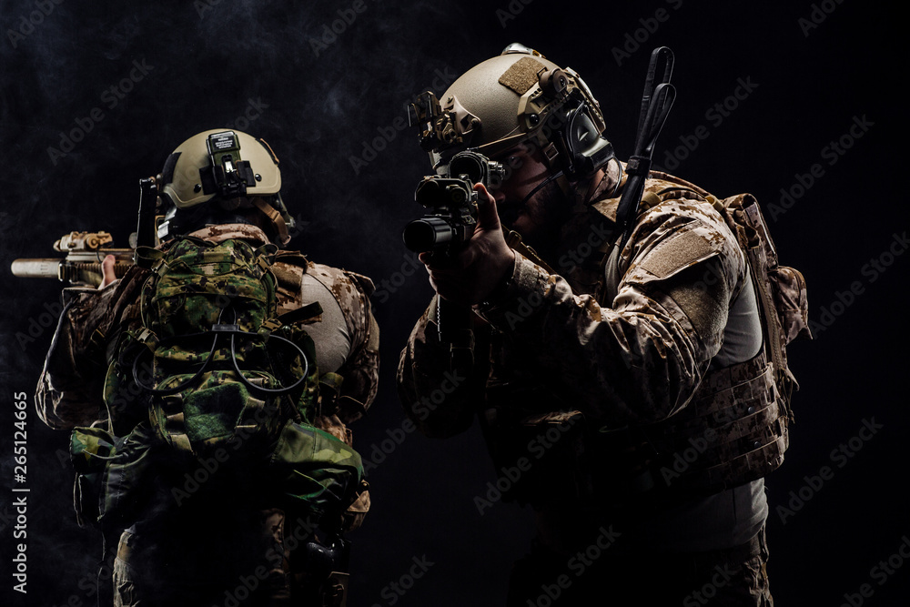 soldiers or private military contractors holding rifle. Image on a black background. war, army, weapon, technology and people concept soldiers or private military contractors holding rifle. Image on a black background. war, army, weapon, technology and people concept