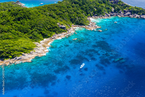 Aerial drone view of boats around the shallow coral reef surrounding beautiful tropical islands  Similan Islands 