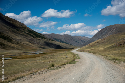 Wildlife Altai. The road, mountains and sky with clouds in summer