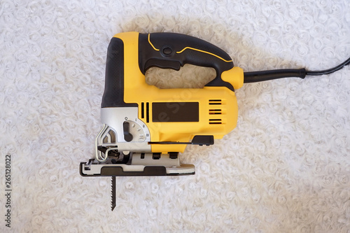 Electric jigsaw machine on a white background. Woodworking tools for industry and production.