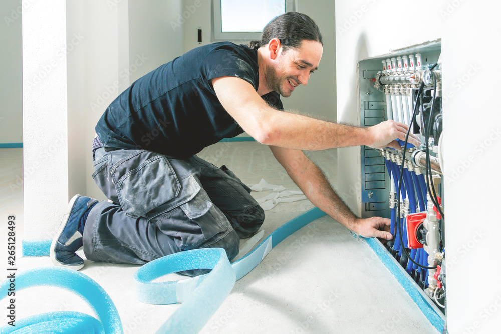 Radiant Floor Heating Installation. Repair floor heating system with insulated metal pipes Radiant Floor Heating Installation. Repair floor heating system with insulated metal pipes