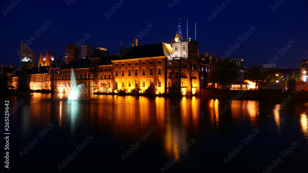 Beautiful view to the House of parliament within the historical Binnenhof with the Hofvijver lake by night in The Hague, Netherlands