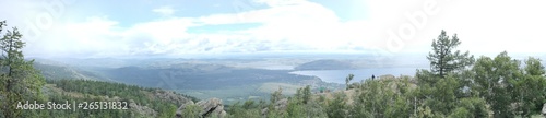 panoramic view from the top of the mountain to the mountain expanses with a lake