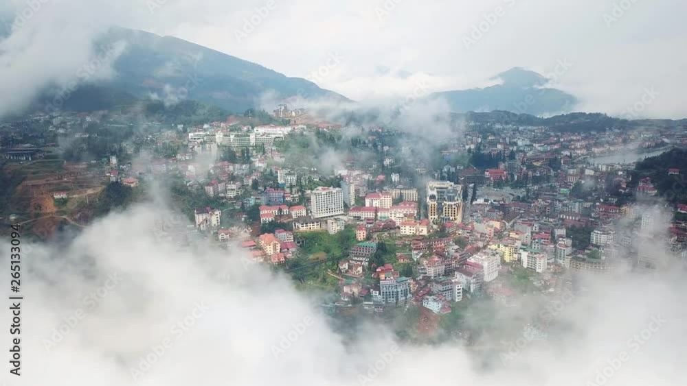 Flight above center of the city in the clouds. Beautifull white smoke fog. Sapa Laocai Vietnam Asia. Summer sunny day. Flight above center of the city in the clouds. Beautifull white smoke fog. Sapa Laocai Vietnam Asia. Summer sunny day.