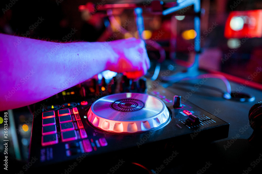 Obraz premium DJ mixing music on console at the night club