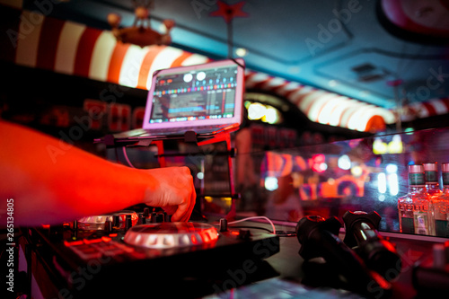 DJ mixing music on console at the night club