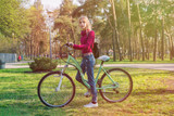 Teenager girl on a bicycle in the park.