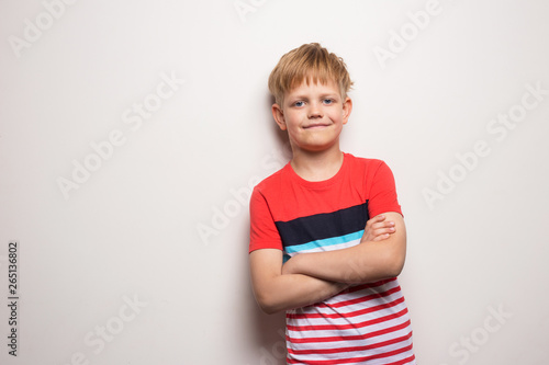 Little smiling boy in t-shirt isolated on white background. Studio portrait