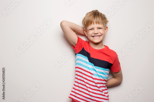 Little smiling boy in t-shirt isolated on white background. Studio portrait