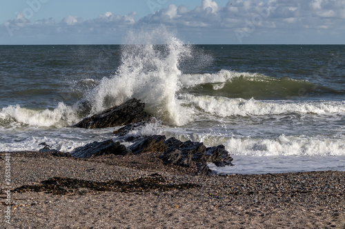 Photography Wave crashes against rock on beach in Dublin