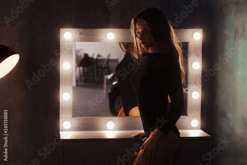Portrait of a beautiful young woman looking into the mirror