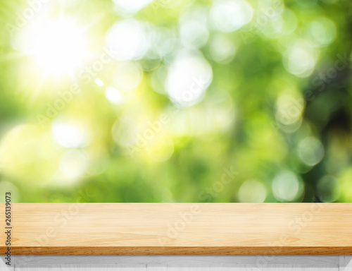 Empty wood plank table top with blur tree in park with bokeh light at background,Mock up template for display of your design,Banner for advertise of product