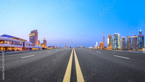 Shanghai modern commercial office buildings and straight asphalt road at night panoramic view