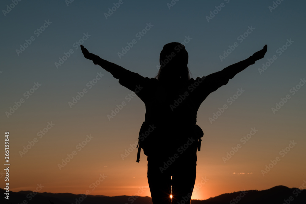 woman silhouette in front of a sunset