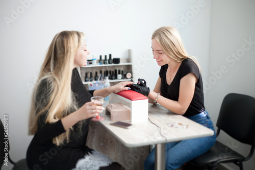 Client and manicurist in the salon. Beauty and fashion industry.